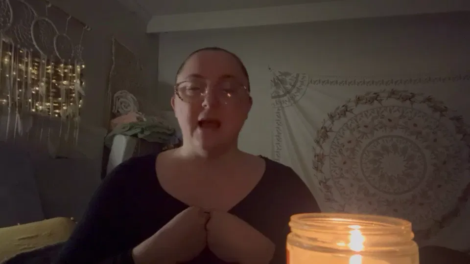 A client speaking beside candlelight in a quiet room