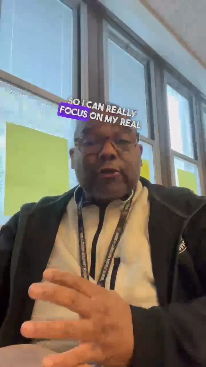 A client sharing a vertical video reflection beside bright windows